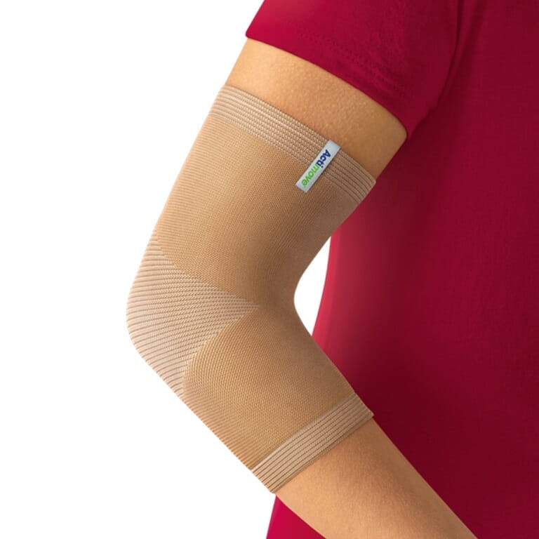 Actimove Arthritis Elbow Support being worn by a model on the relevant joint, demonstrating fit and coverage.