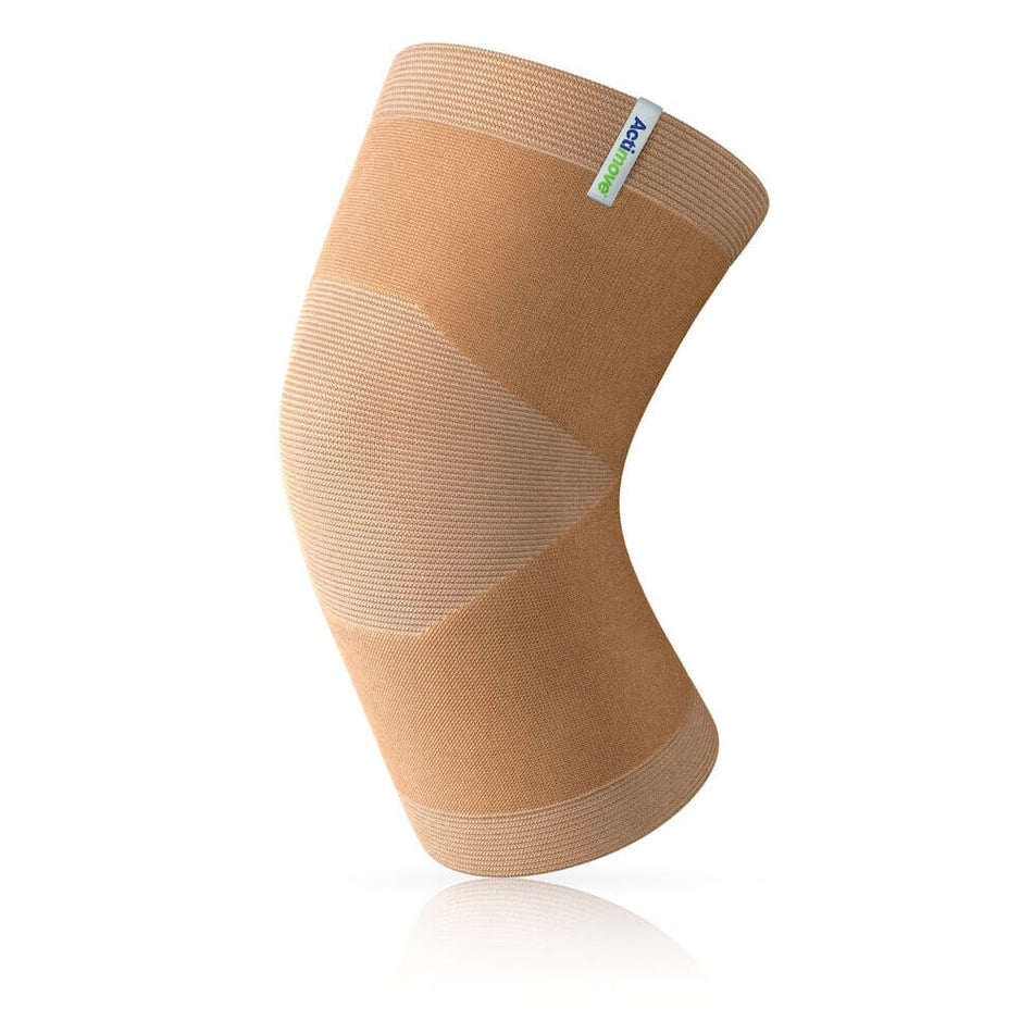 Actimove Arthritis Knee Support being worn by a model on the relevant joint, demonstrating fit and coverage.