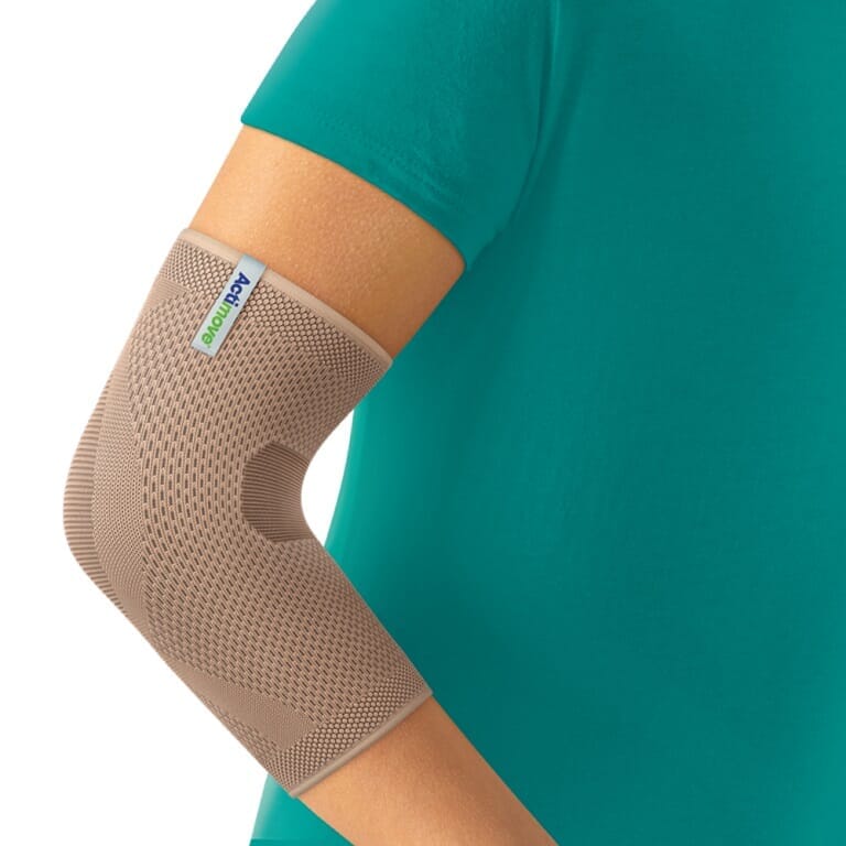 Actimove Elbow Support being worn by a model on the relevant joint, demonstrating fit and coverage.