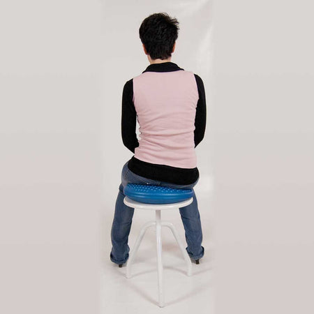 DiscoSit Balance Air Cushion cushion being compressed by a hand to show the level of support.