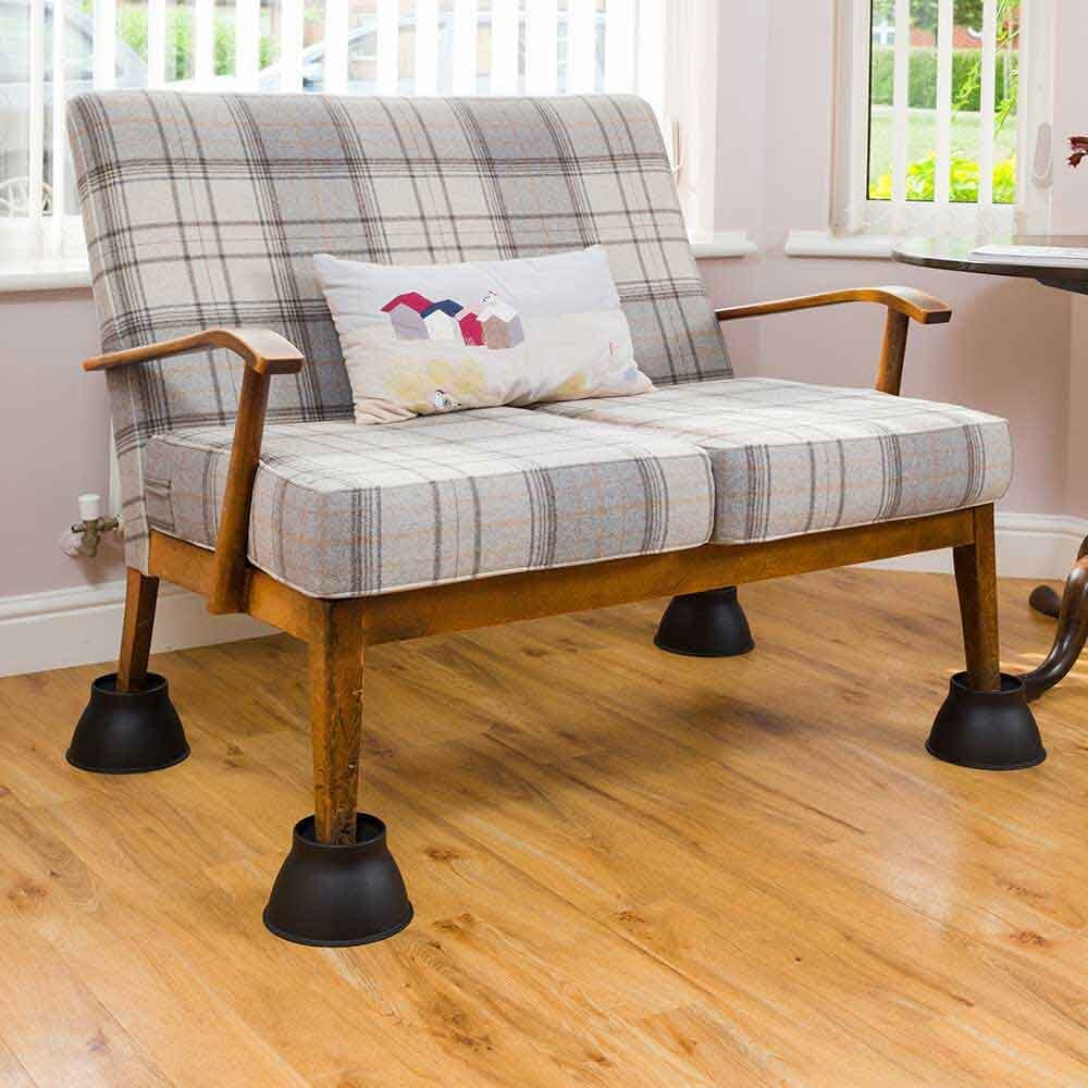 Lifestyle image of Elephant Feet Furniture Raiser-Pack of 4 in Black being used in a real-life setting.