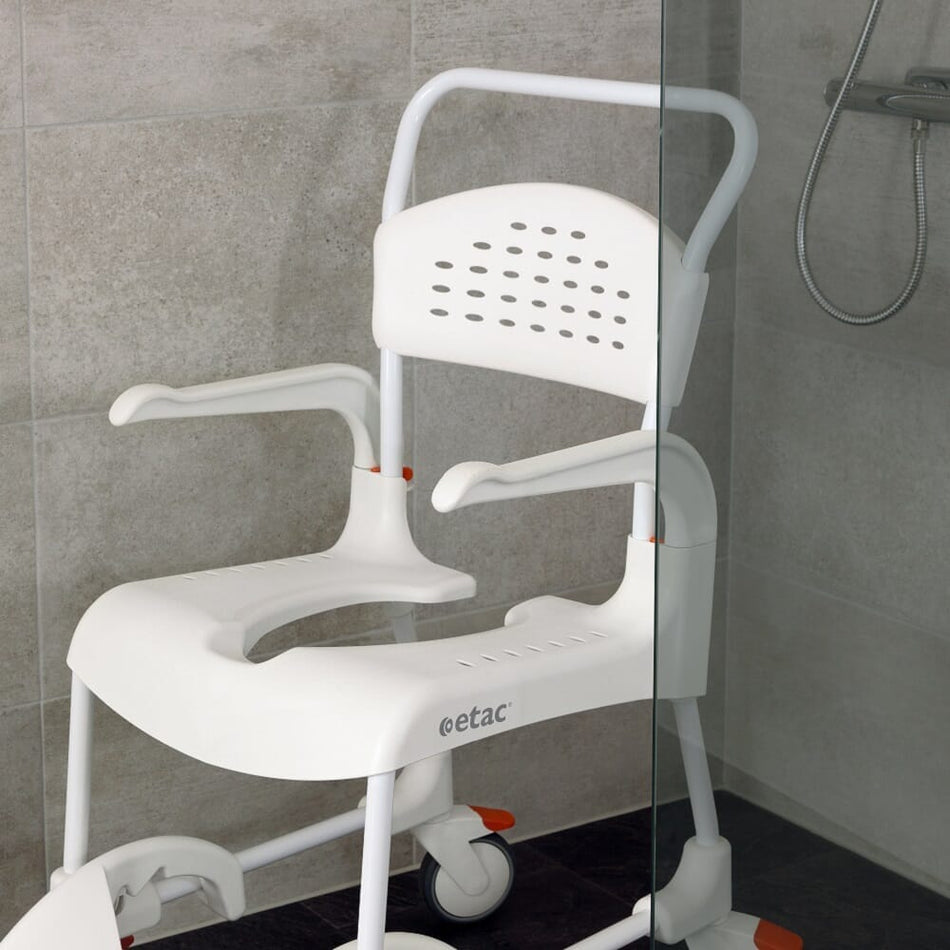 Etac Clean Shower Commode Chair with lid closed, highlighting the padded seat and discreet design.