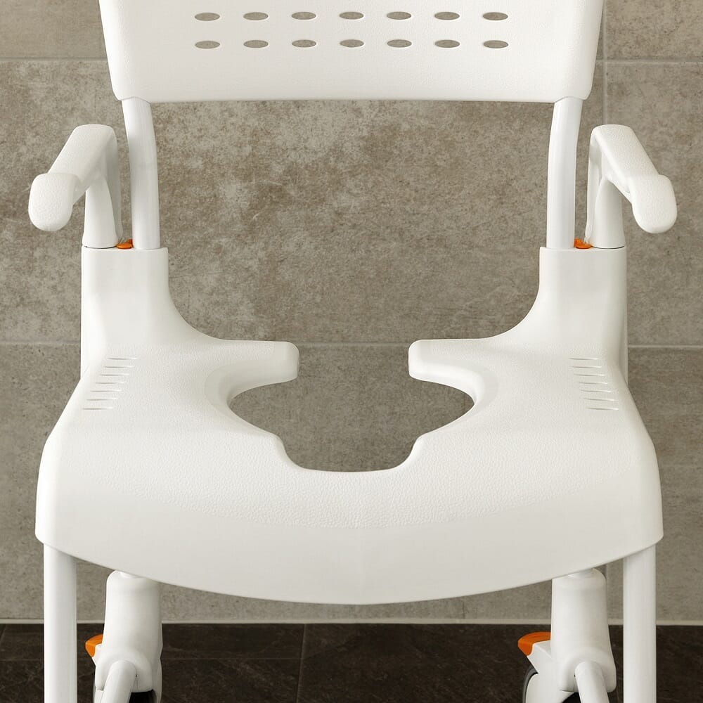 Etac Clean Shower Commode Chair positioned in a home environment such as a bedroom or bathroom, demonstrating its discreet appearance.