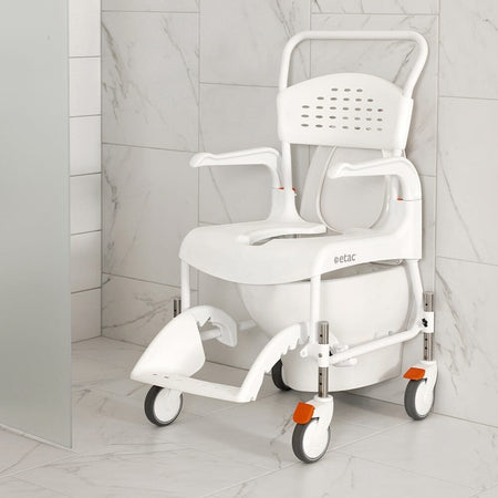 Etac Clean Shower Commode Chair with lid closed, highlighting the padded seat and discreet design.