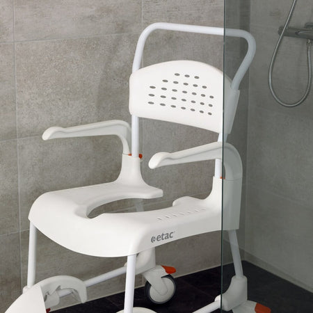 Etac Clean Shower Commode Chair positioned in a home environment such as a bedroom or bathroom, demonstrating its discreet appearance.