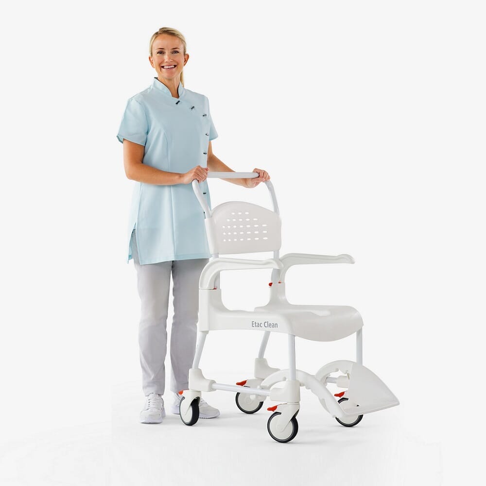 Demonstration of removing the commode pan or adjusting the height on Etac Clean Shower Commode Chair.