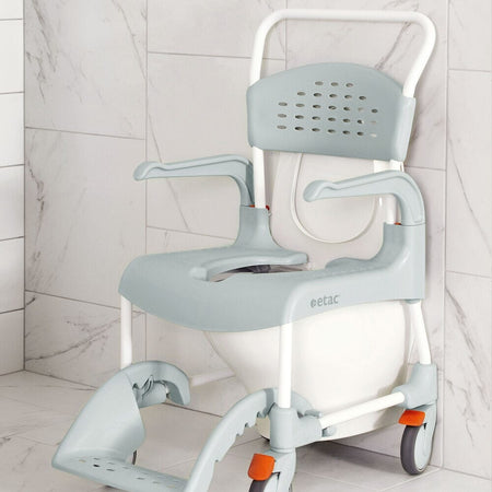 Etac Clean Shower Commode Duo Pack with lid closed, highlighting the padded seat and discreet design.