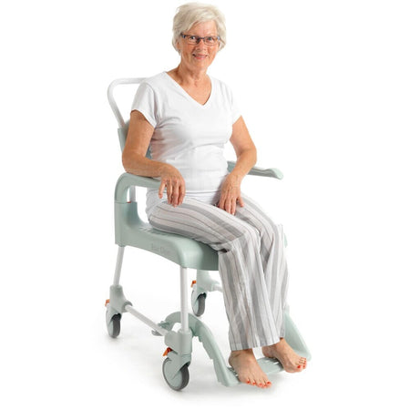 Etac Clean Shower Commode Duo Pack positioned in a home environment such as a bedroom or bathroom, demonstrating its discreet appearance.