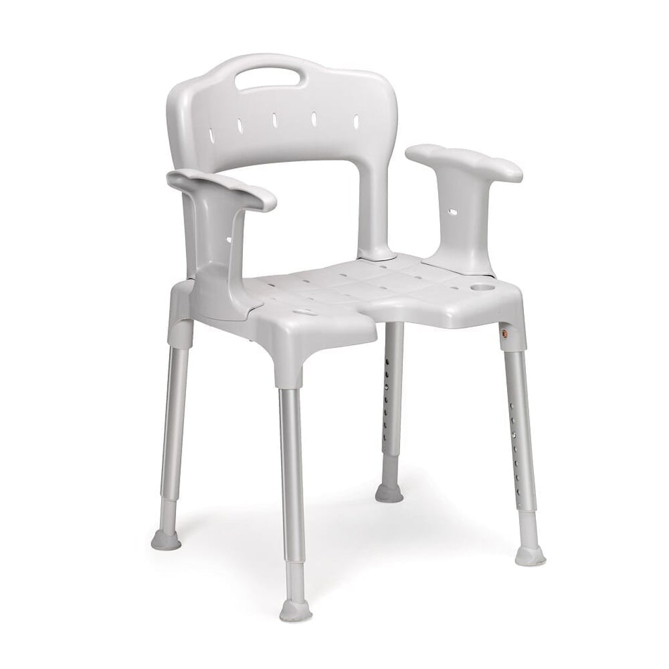 Angled view of Etac Swift Shower Chair with moulded seat, supportive backrest and height-adjustable legs on a plain background.