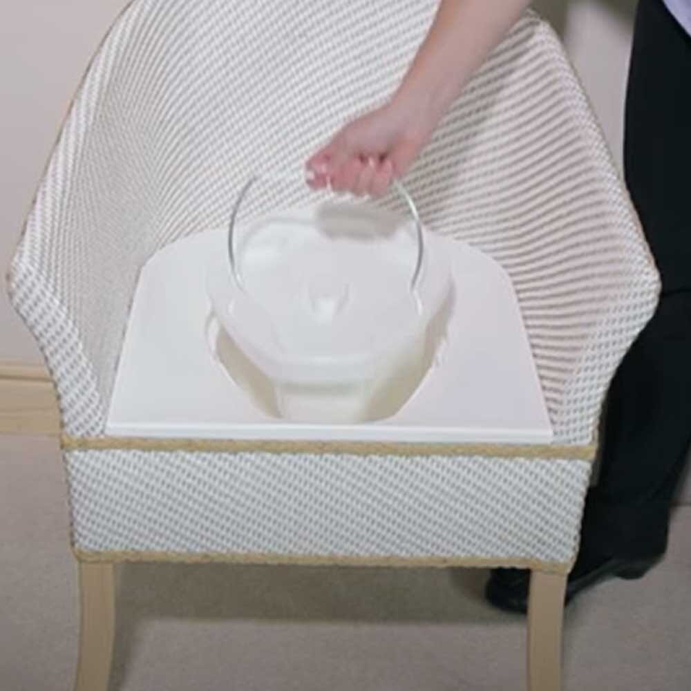 Gordon Ellis Ashby Commode Pan Lid positioned in a home environment such as a bedroom or bathroom, demonstrating its discreet appearance.