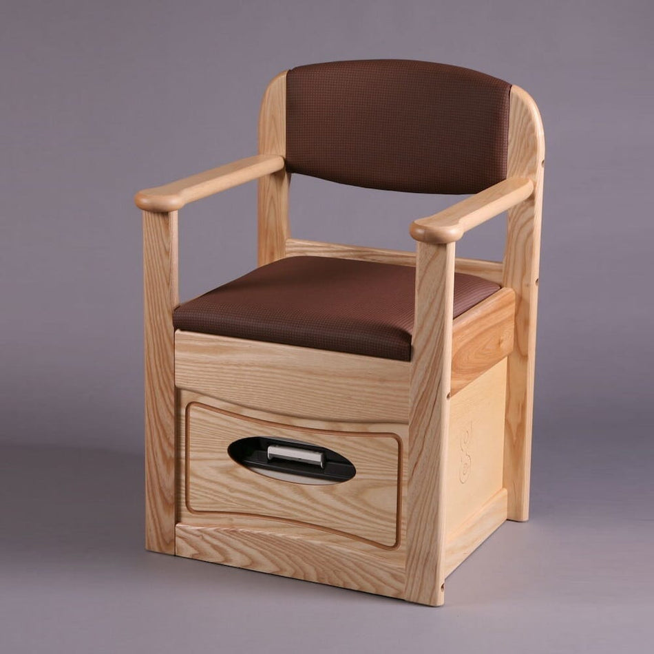 Gordon Ellis Royale Flushing Commode with lid closed, highlighting the padded seat and discreet design.