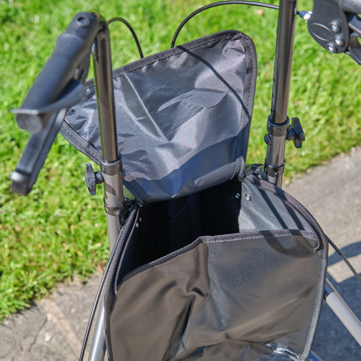 Side view of NRS 3 Wheel Aluminium Rollator three-wheel rollator, highlighting the triangular frame and rear wheels.