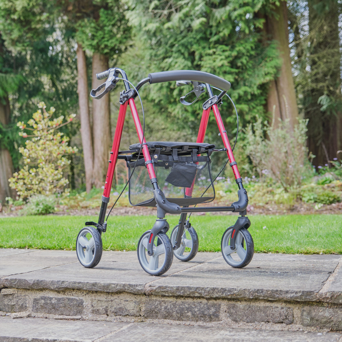 Fully folded NRS 4 Wheel Lightweight Rollator rollator lying flat, showing the triple-fold mechanism and compact size.