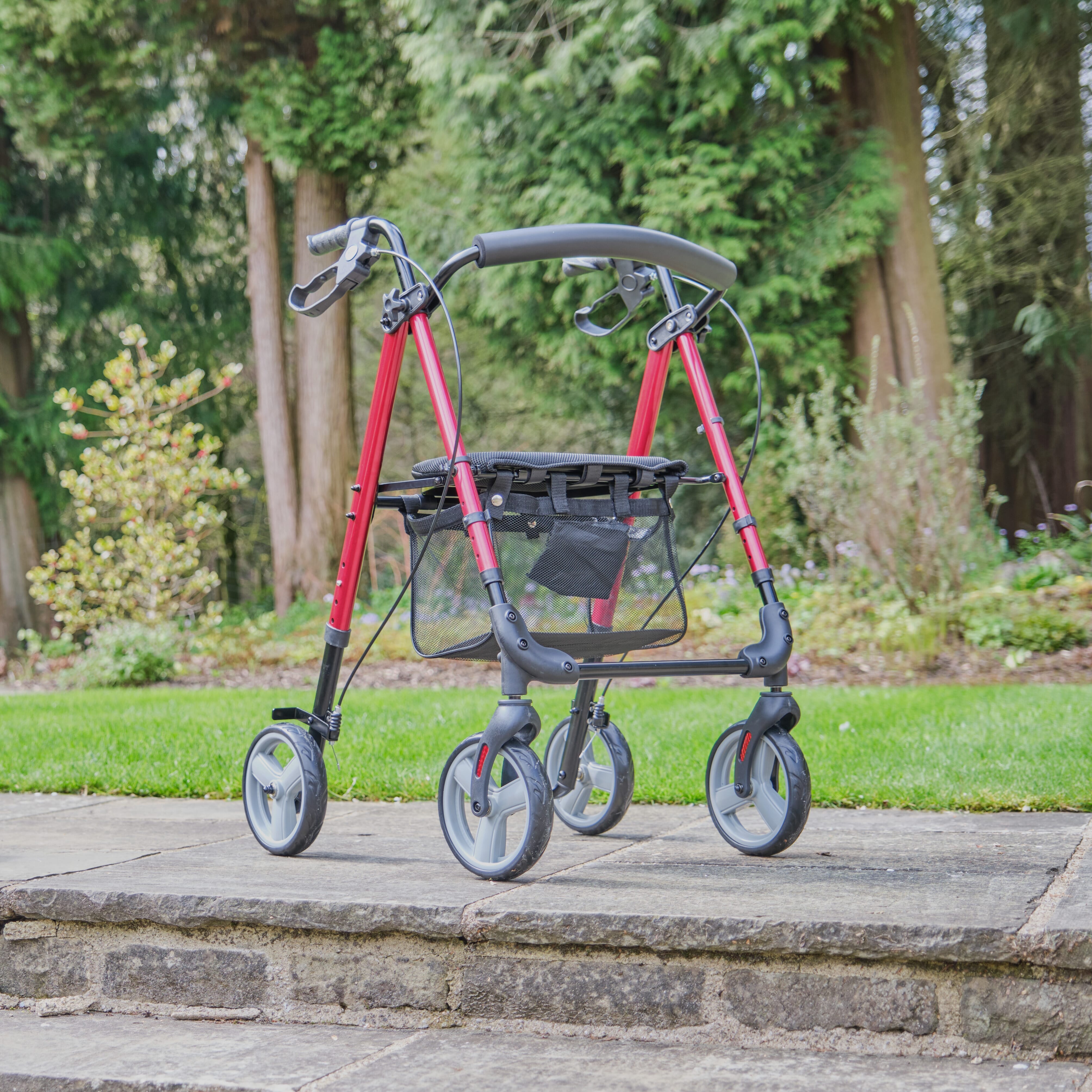 Fully folded NRS 4 Wheel Lightweight Rollator rollator lying flat, showing the triple-fold mechanism and compact size.