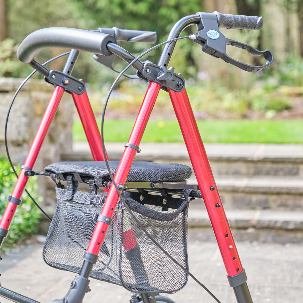 Close-up of a folding release lever on NRS 4 Wheel Lightweight Rollator rollator being operated by hand.