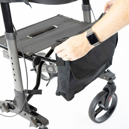 Person removing or attaching the under-seat storage bag on NRS 4 Wheel Triple Fold Aluminium Rollator rollator.