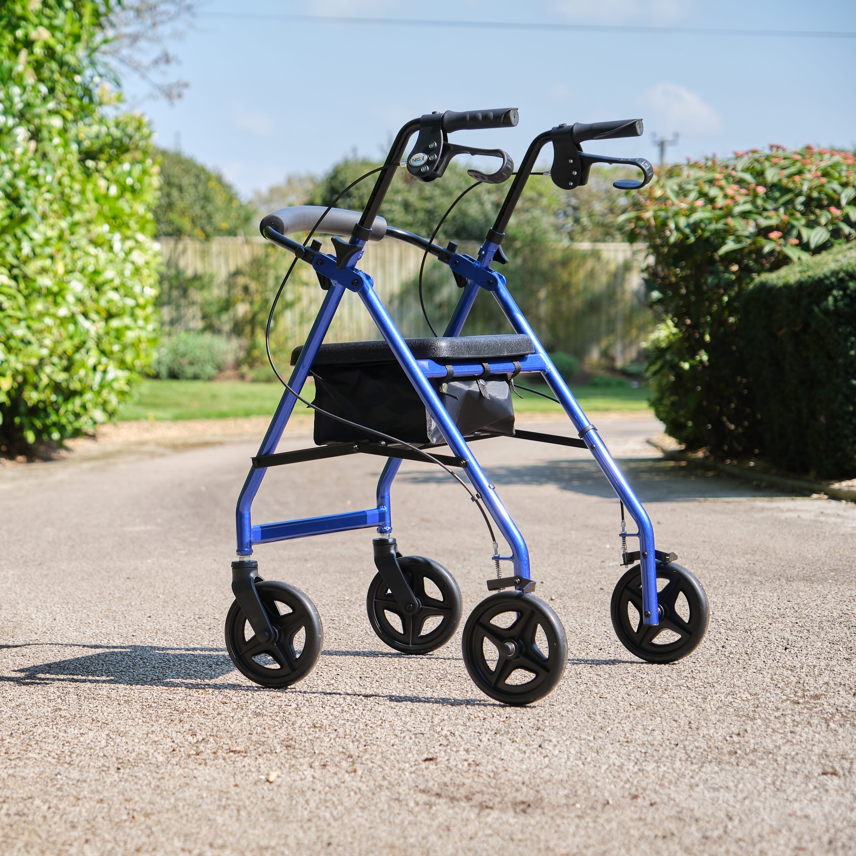 Fully folded NRS A-Series Lightweight 4 Wheel Rollator rollator lying flat, showing the triple-fold mechanism and compact size.