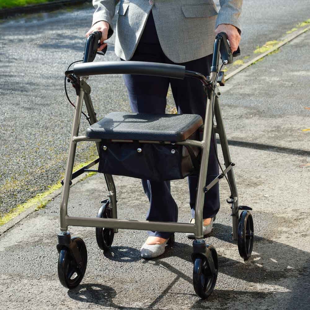 Fully folded NRS A-Series Lightweight 4 Wheel Rollator rollator lying flat, showing the triple-fold mechanism and compact size.