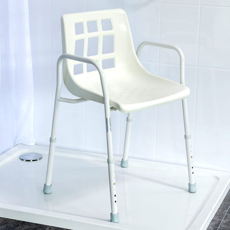 Angled view of NRS Adjustable Economy Value Shower Chair with moulded seat, supportive backrest and height-adjustable legs on a plain background.