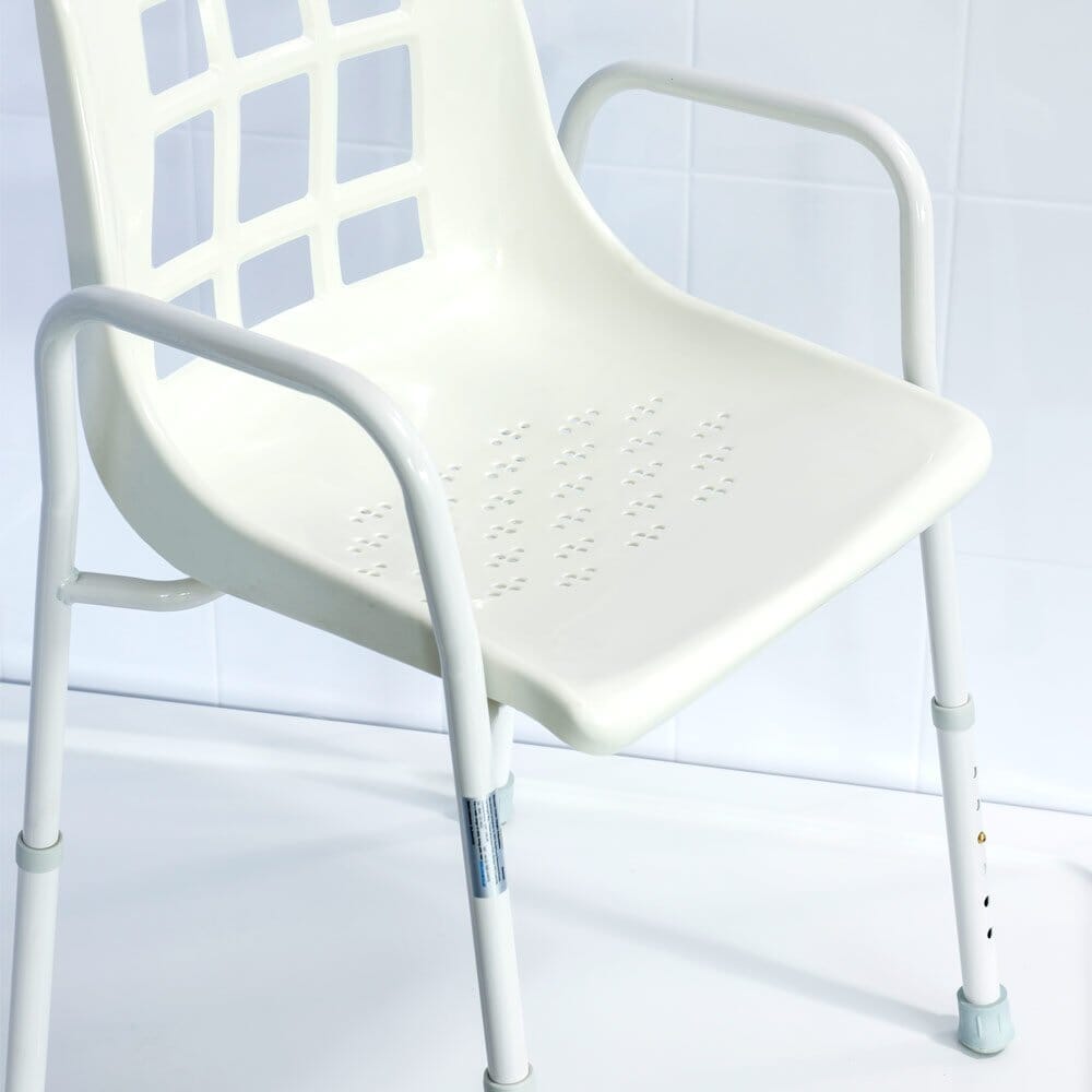 Front view of NRS Adjustable Economy Value Shower Chair showing drainage holes in the seat and the supportive backrest design.