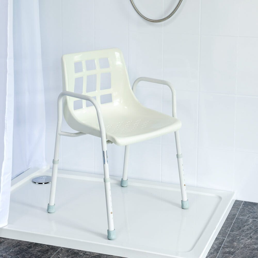 Close-up of the seat on NRS Adjustable Economy Value Shower Chair, showing drainage holes and textured surface for comfort.