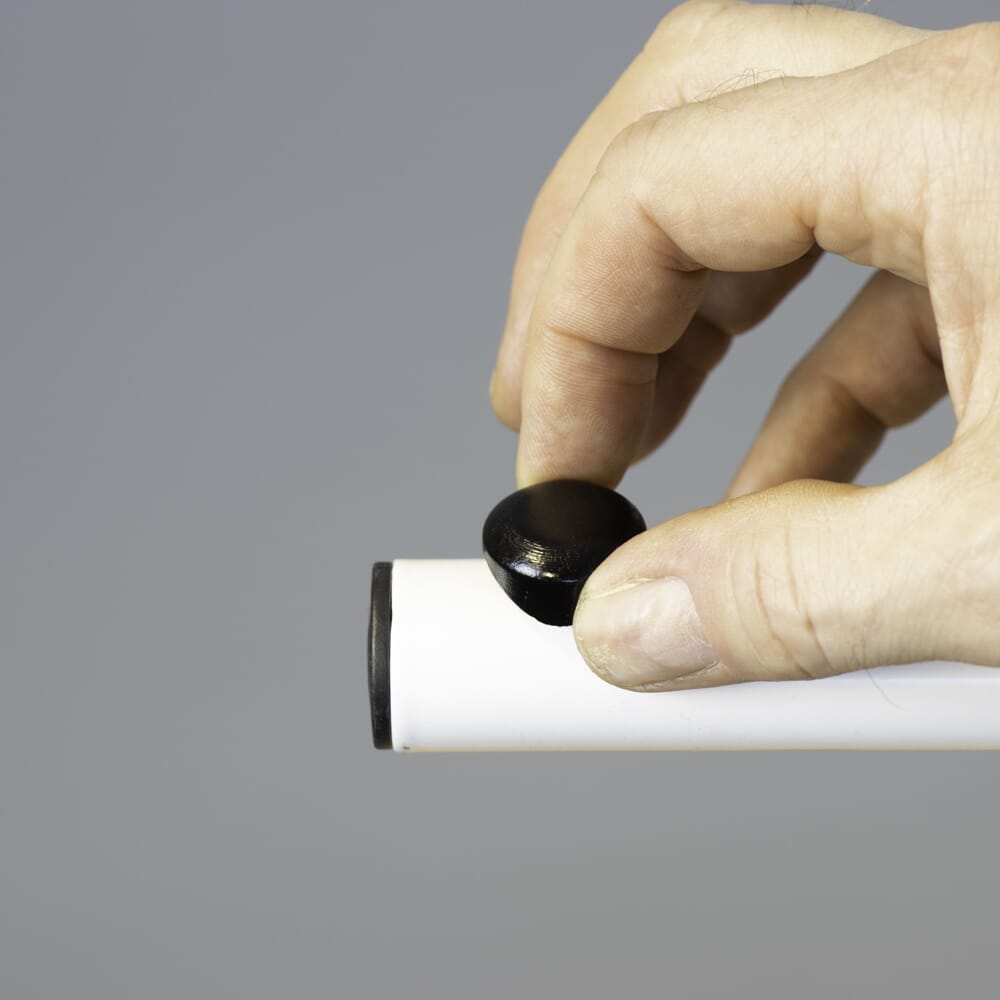 Close-up of a push button or knob on NRS Beech Overbed Overchair Table's frame used for adjusting height or tilt.