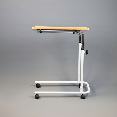 Side view of NRS Beech Overbed Overchair Table with the table top level at its lowest height.