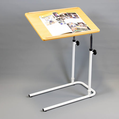 NRS Beech Overbed Overchair Table in use with a magazine or book on the table top, demonstrating its generous surface area.