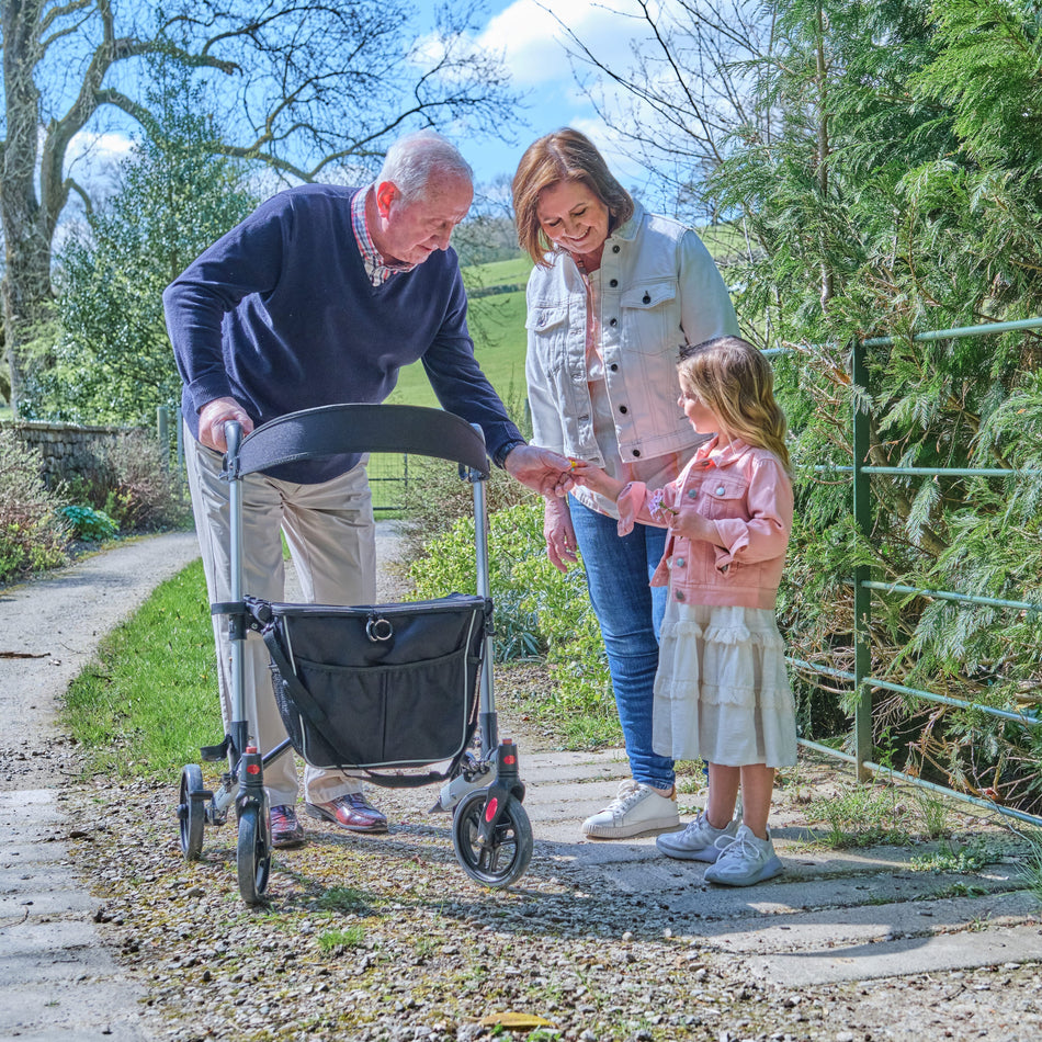 Front view of NRS Compact Easy Rollator rollator with seat and padded backrest, showing the handlebars and brake cables.
