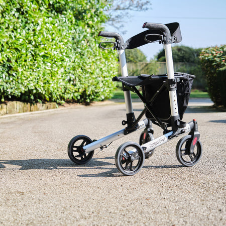 Close-up of a folding release lever on NRS Compact Easy Rollator rollator being operated by hand.