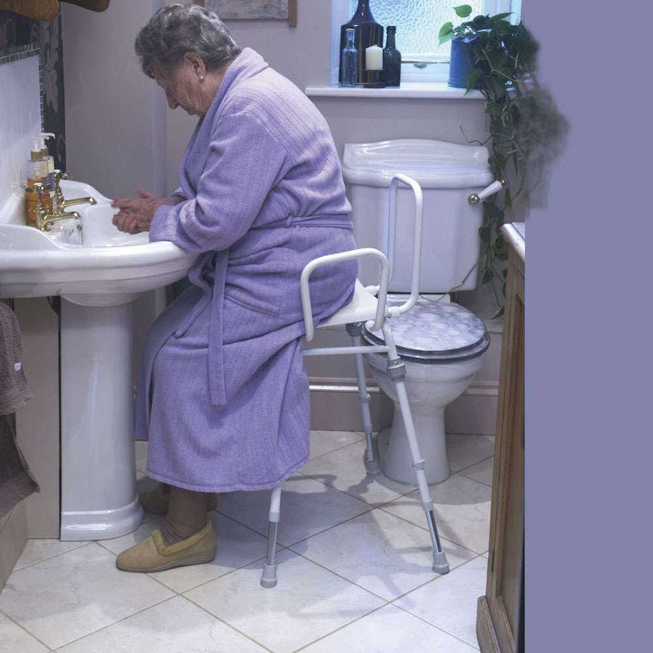 Alternative view of NRS Compact Perching Stool with Arms and Back, showing different angle or usage.