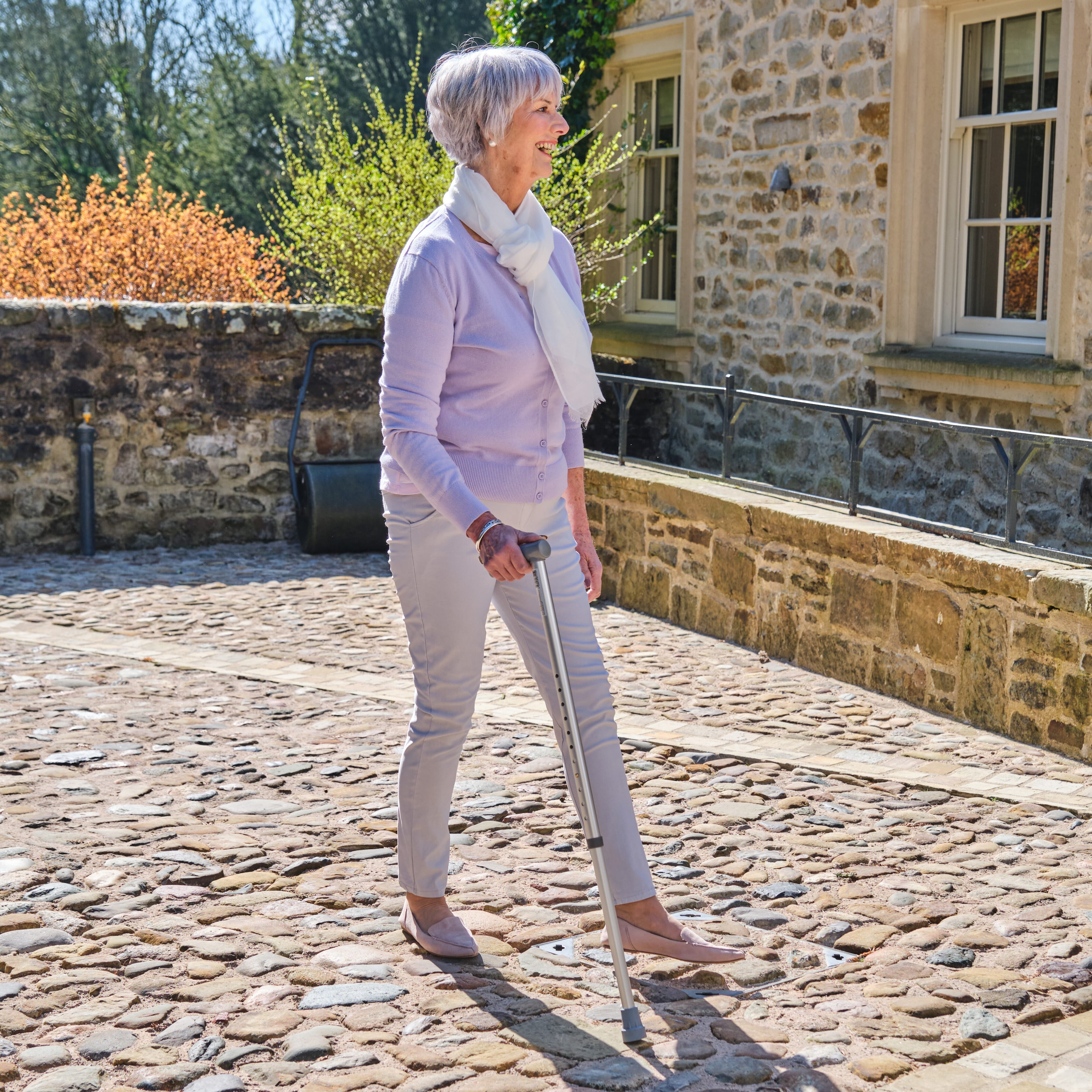 NRS Coopers Adjustable Walking Stick walking stick in use by a person, demonstrating balance and support.