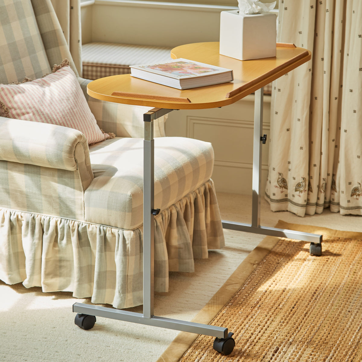 Close-up of hands adjusting the height or tilt of NRS Curved Adjustable Overbed Table, showing the easy-turn knobs.