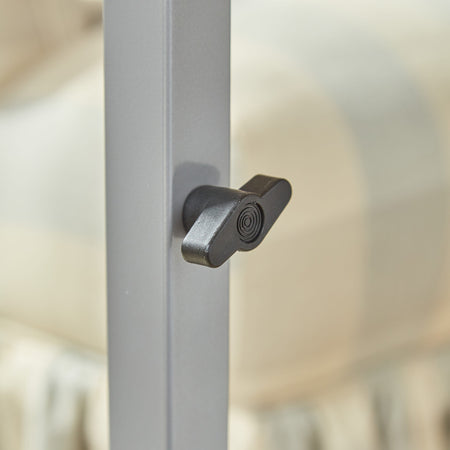 Close-up of a push button or knob on NRS Curved Adjustable Overbed Table's frame used for adjusting height or tilt.