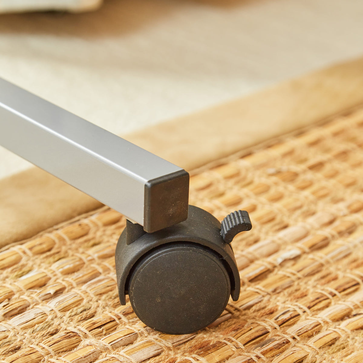 Side view of NRS Curved Adjustable Overbed Table with the table top level at its lowest height.