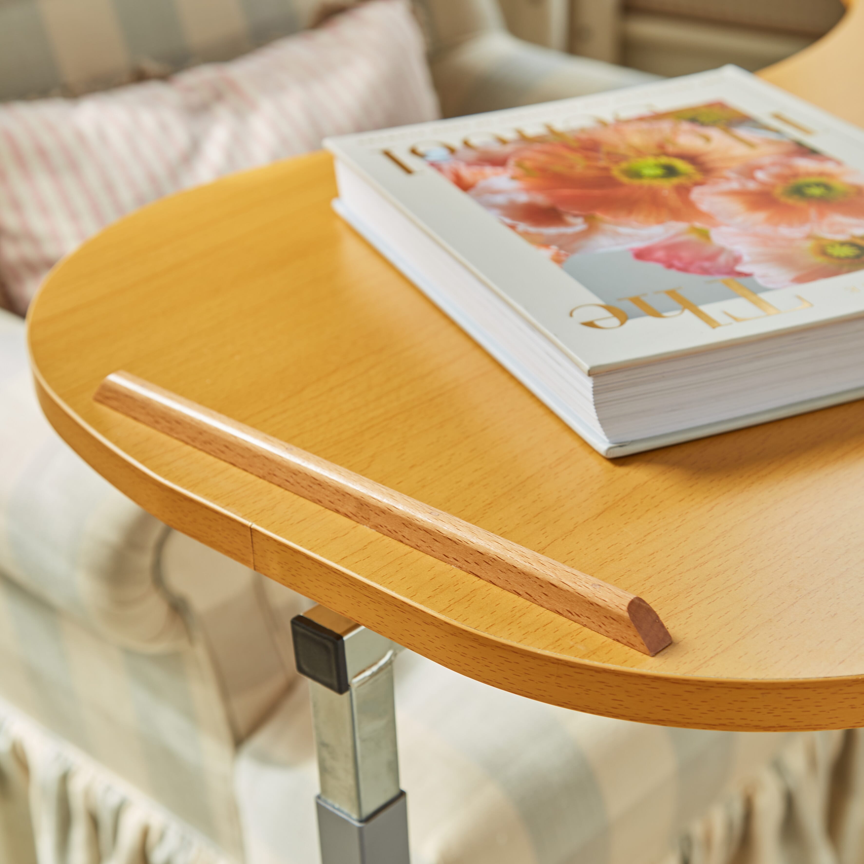 Close-up of the tubular base of NRS Curved Adjustable Overbed Table, highlighting the sturdy steel frame.