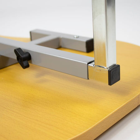 Close-up of the castor wheels on NRS Curved Adjustable Overbed Table, showing the smooth-rolling casters and brake mechanism.