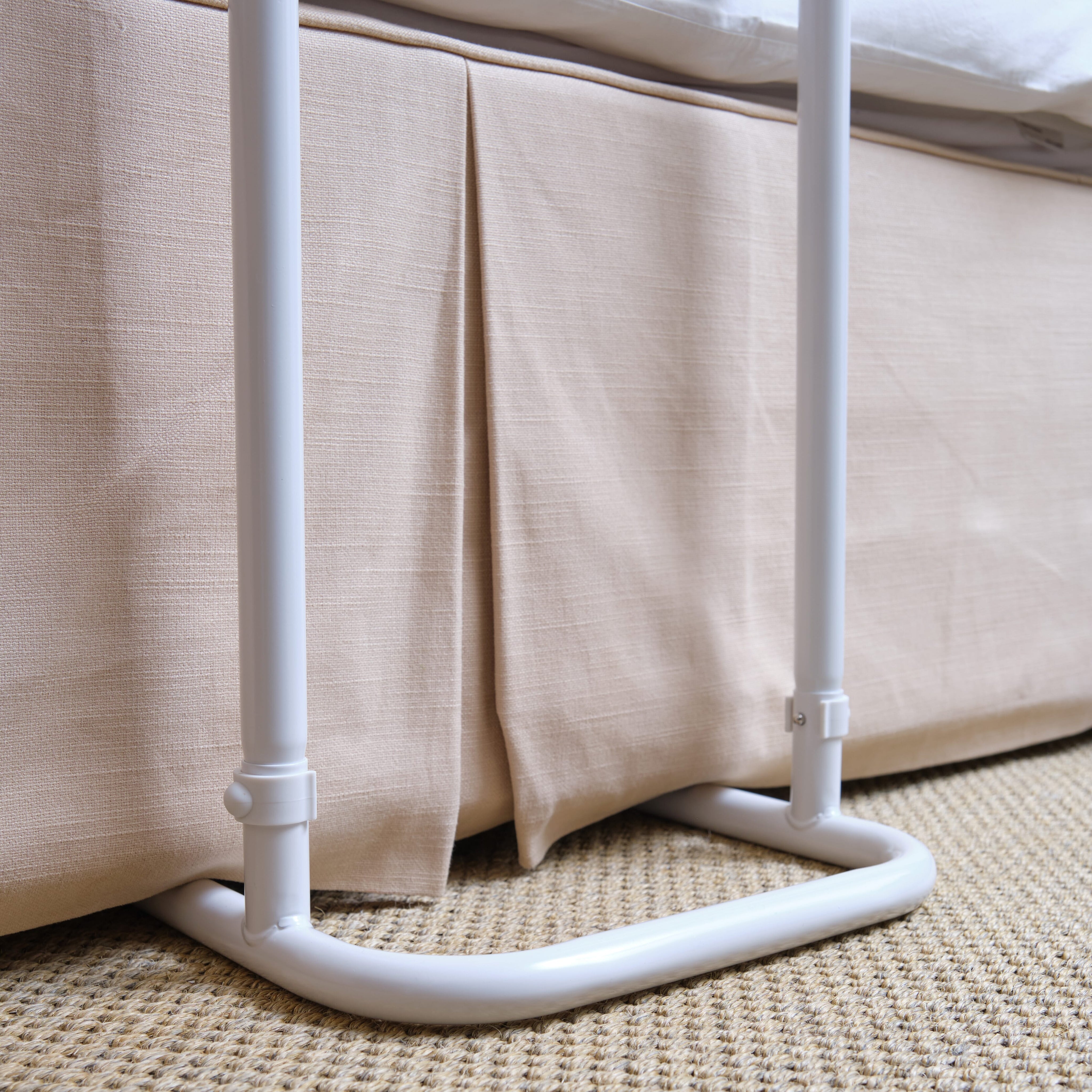 Close-up of a push button or knob on NRS Divan Overbed Table's frame used for adjusting height or tilt.