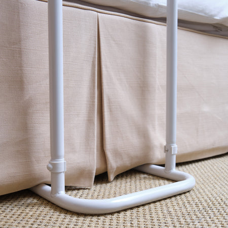 Close-up of a push button or knob on NRS Divan Overbed Table's frame used for adjusting height or tilt.