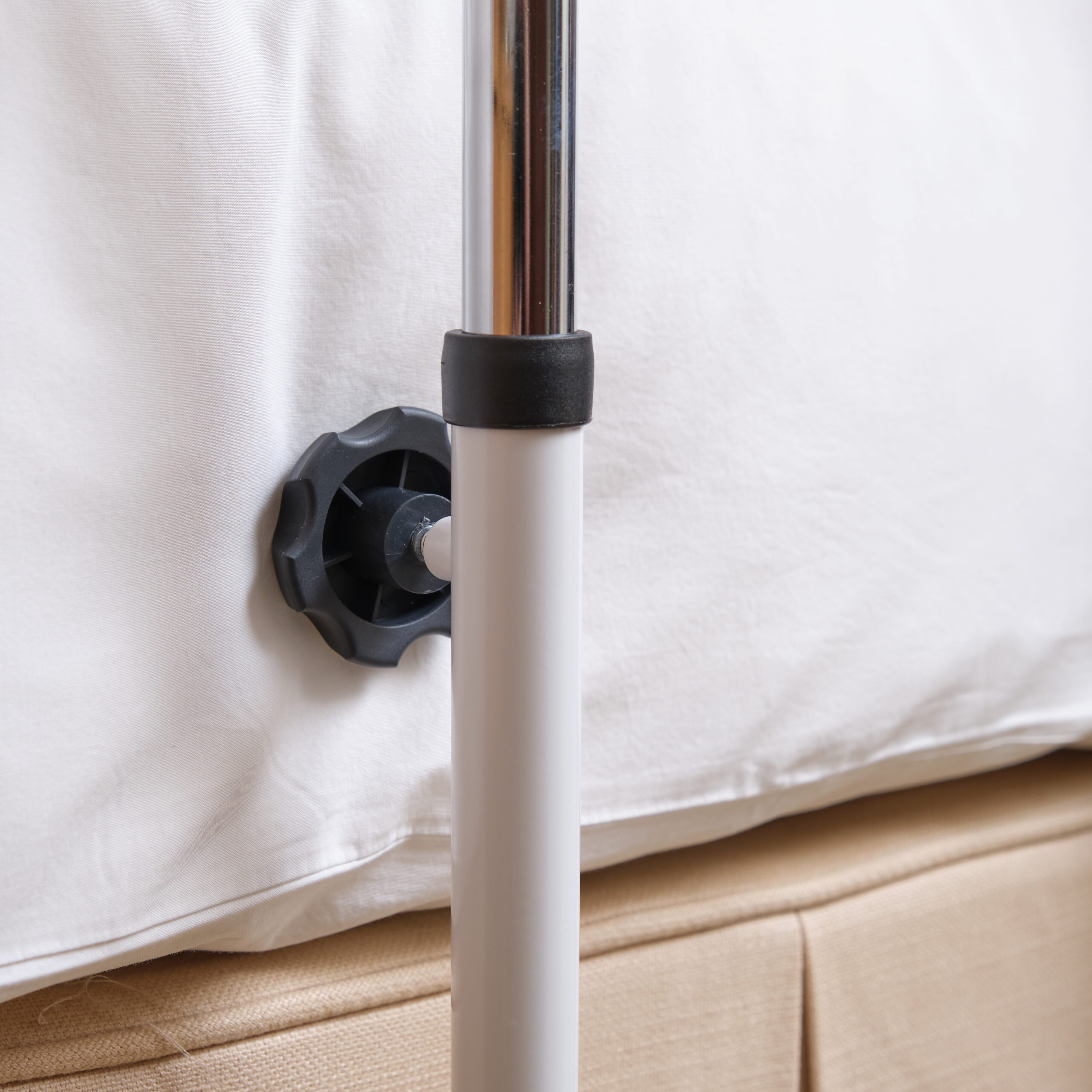 Side view of NRS Divan Overbed Table with the table top level at its lowest height.