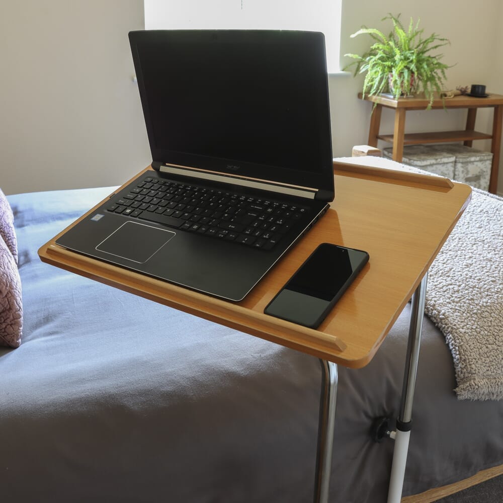 Close-up of the tubular base of NRS Divan Overbed Table, highlighting the sturdy steel frame.