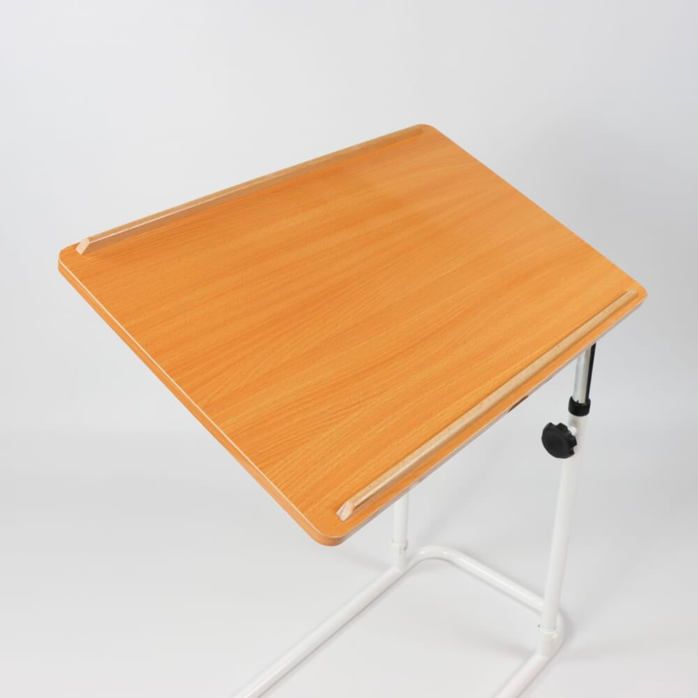 NRS Divan Overbed Table in use with a magazine or book on the table top, demonstrating its generous surface area.