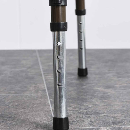 Demonstration of removing the commode pan or adjusting the height on NRS Dovedale Adjustable Commode.