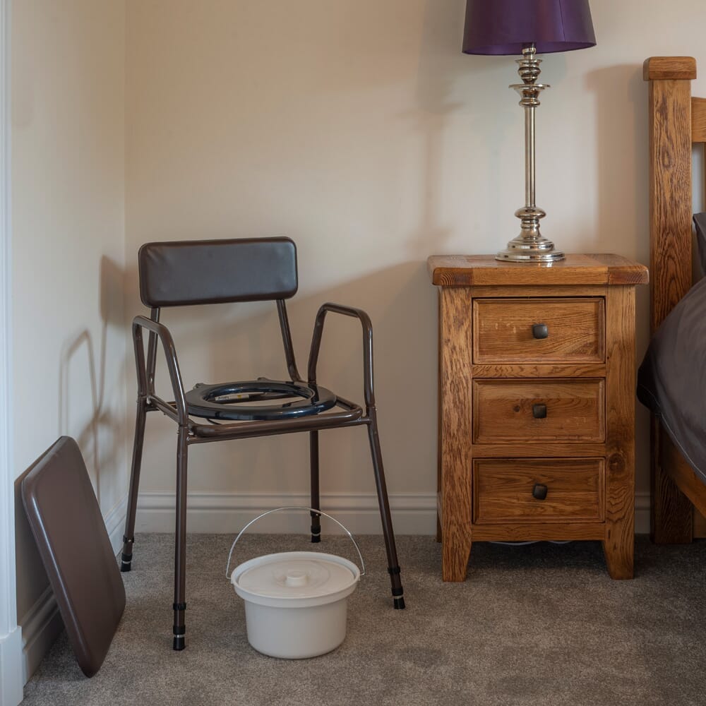 Close-up of NRS Dovedale Adjustable Commode with Detachable Arms seat ring and supportive arms, showing comfort and stability.