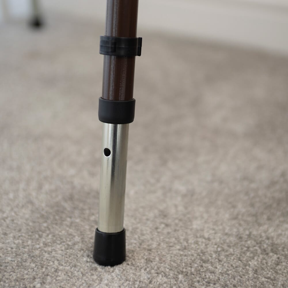 NRS Dovedale Adjustable Commode with Detachable Arms in use in a home setting, with lid open to illustrate accessibility and convenience.