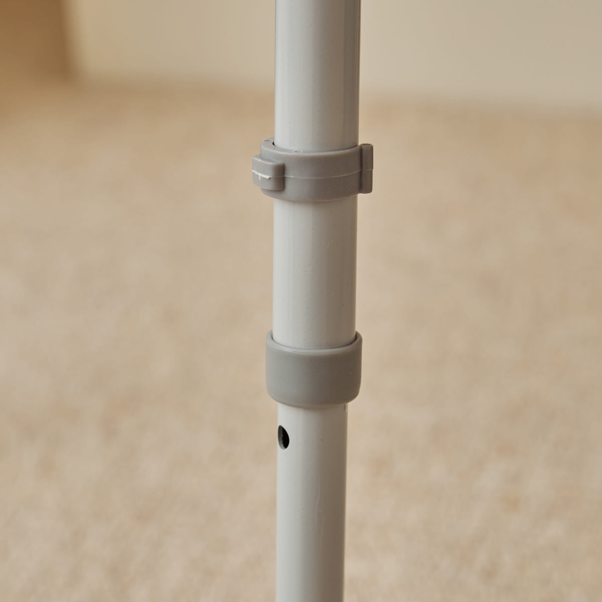 NRS Dovedale Comfort Commode positioned in a home environment such as a bedroom or bathroom, demonstrating its discreet appearance.