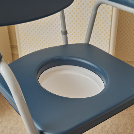 Demonstration of removing the commode pan or adjusting the height on NRS Dovedale Comfort Commode.