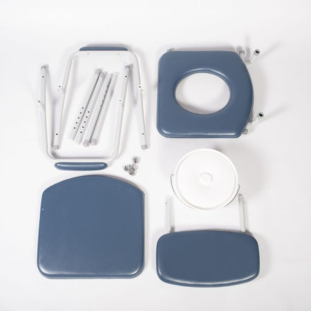 Person emptying or cleaning the commode pan of NRS Dovedale Comfort Commode into a standard toilet.
