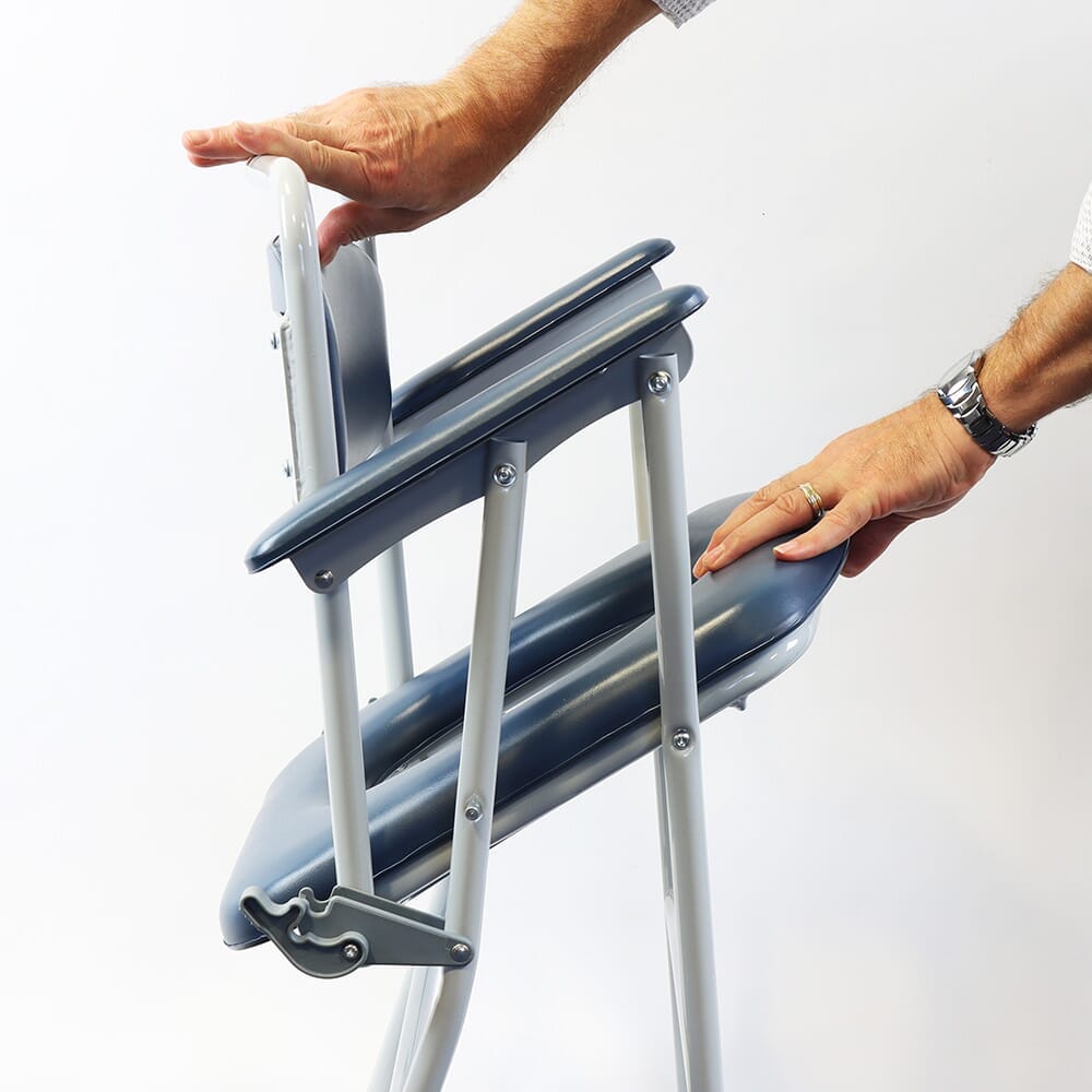 Demonstration of removing the commode pan or adjusting the height on NRS Dovedale Folding Commode.