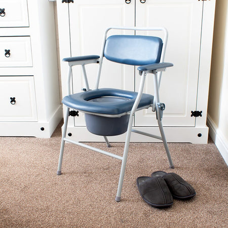 NRS Dovedale Folding Commode in use in a home setting, with lid open to illustrate accessibility and convenience.
